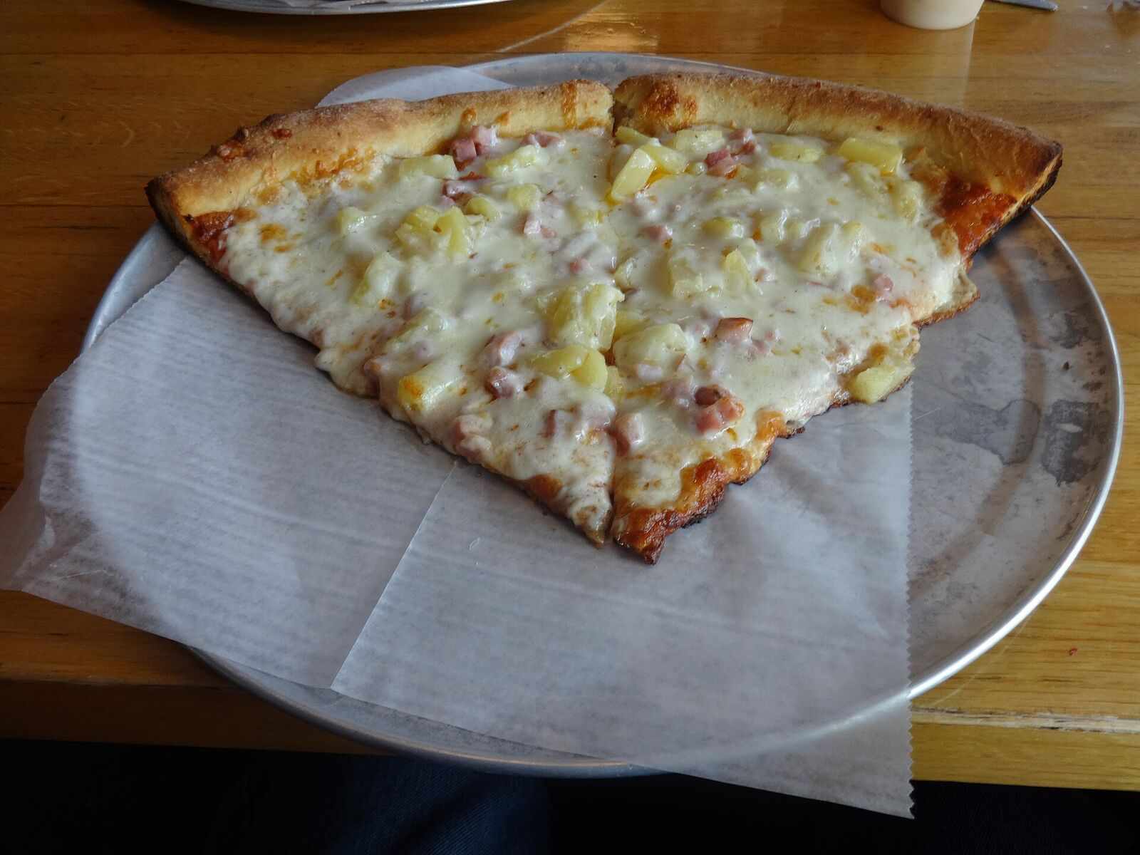 Two big pizza slices on a metal tray